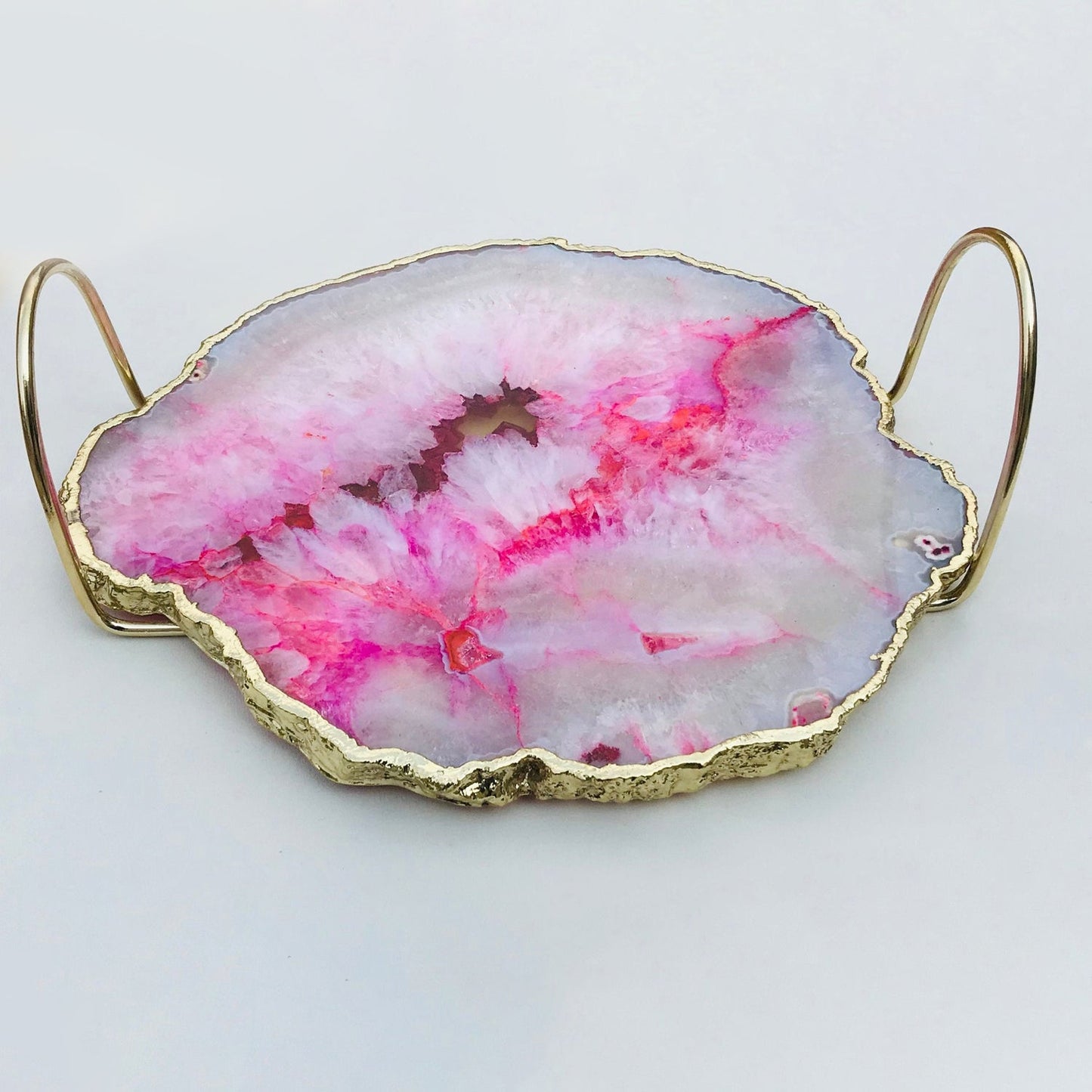 Pink agate organic edge tray with brass loop handles — styled tabletop view