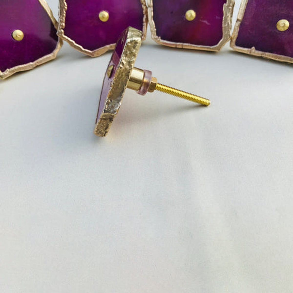 Four slices with one on its side showing the long brass screw