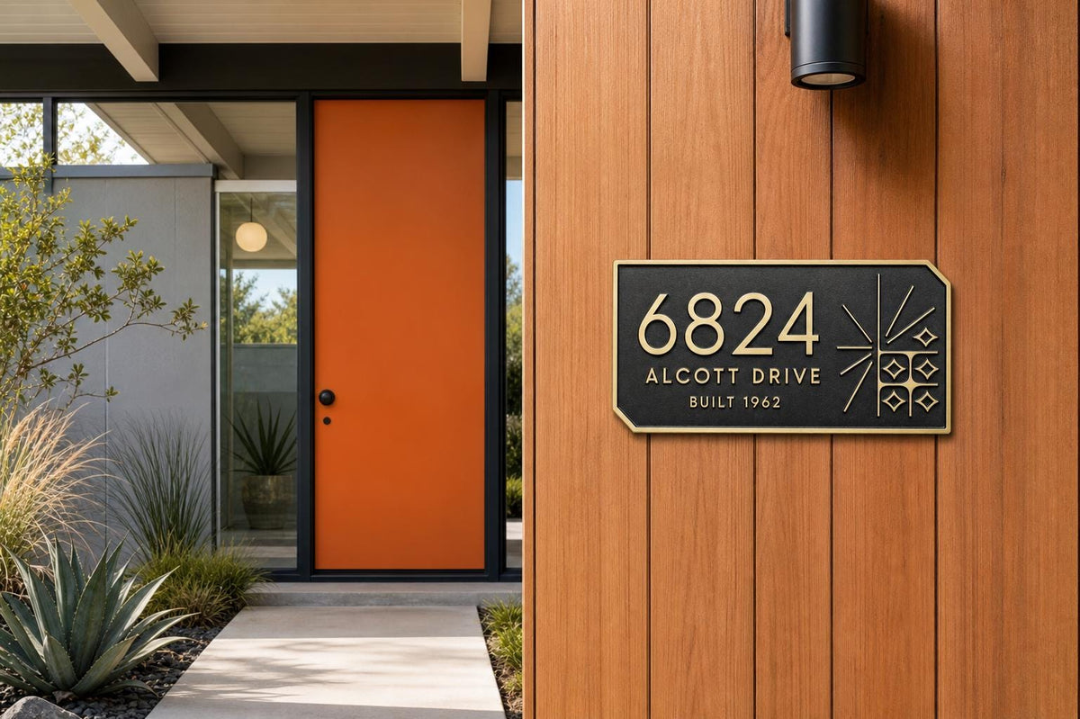 Mid-Century Modern plaque pictured beside an orange entrance door