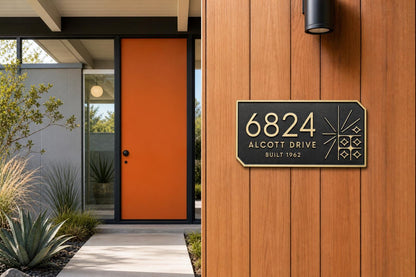 Mid-Century Modern plaque pictured beside an orange entrance door