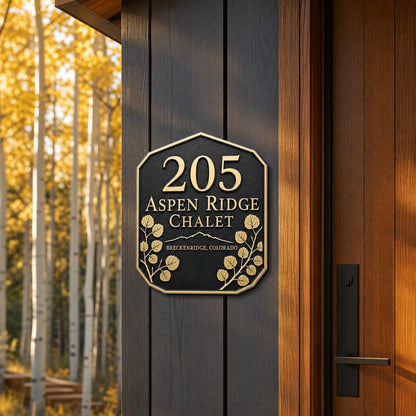 Aspen Leaf plaque pictured beside a wooden entrance and autumn foliage