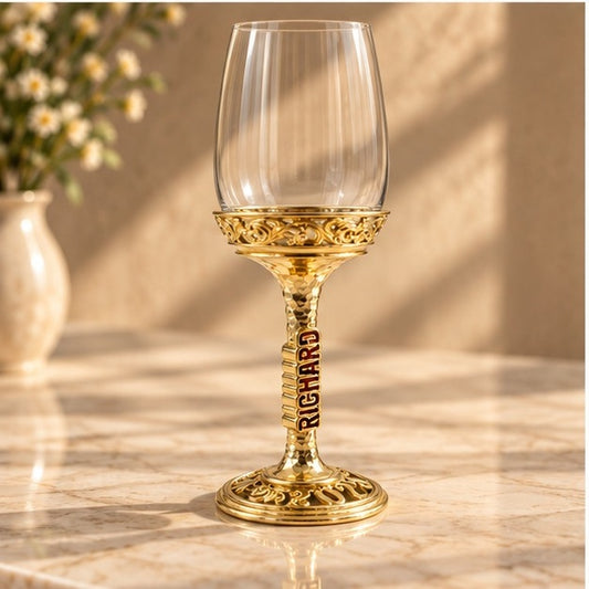 The Block wine glass, gold filigree stem and base, on a marble counter