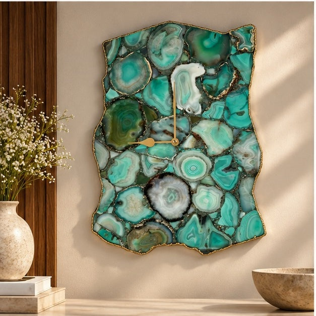 Green agate wall clock on a warm wall beside a plant and a wooden bowl