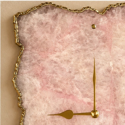 Close view of the pink rose quartz face, its gold organic edge and gold hands