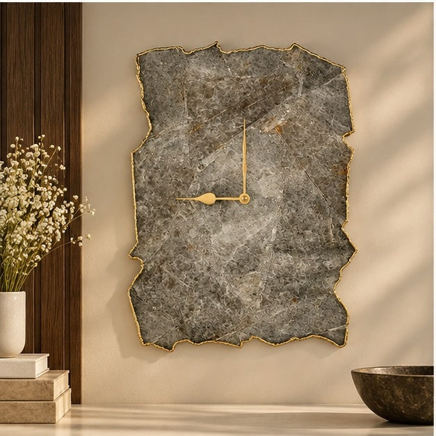 Grey agate wall clock on a warm wall beside a plant and wooden bowls