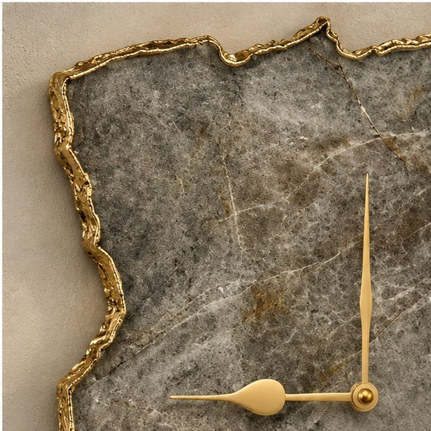 Close view of the grey agate surface, its gold organic edge and gold hands