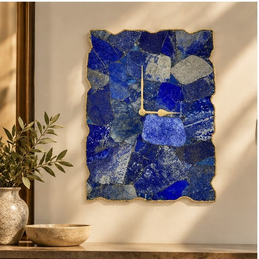 Large lapis lazuli wall clock on a warm wall above a console with a plant and bowl