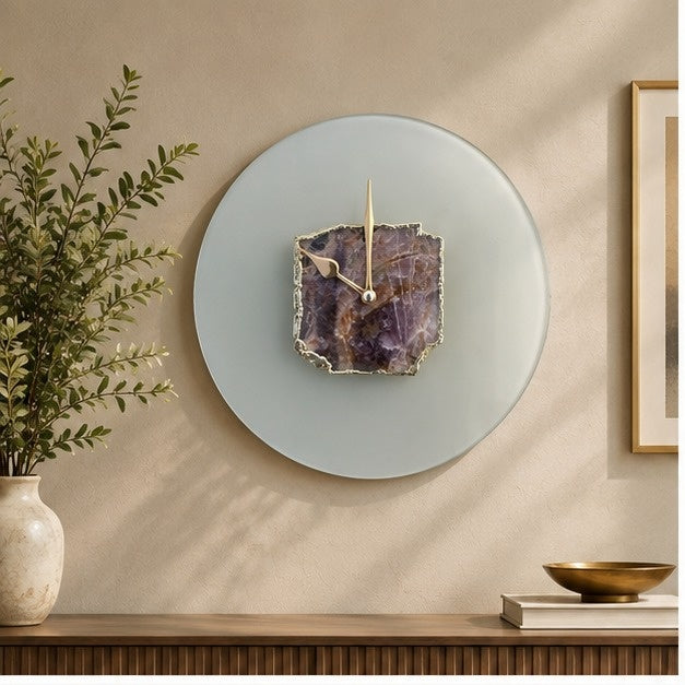 Frosted glass wall clock with a purple amethyst slab at its centre, above a console