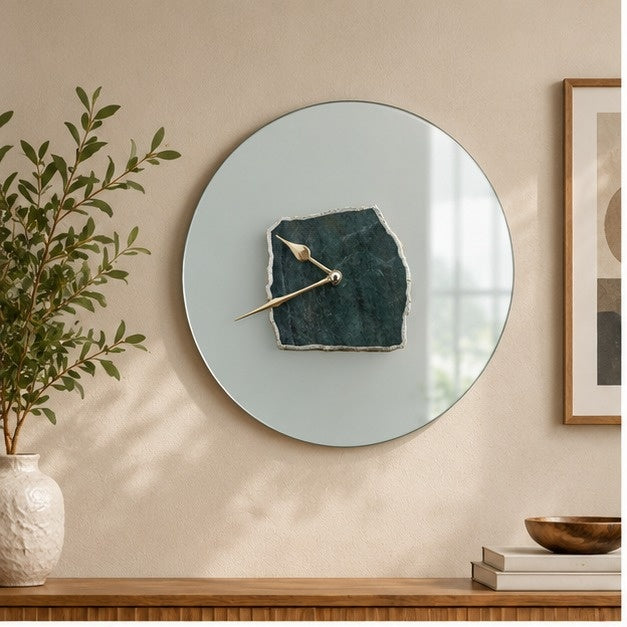 Frosted glass wall clock with a dark green aventurine slab at its centre, above a console