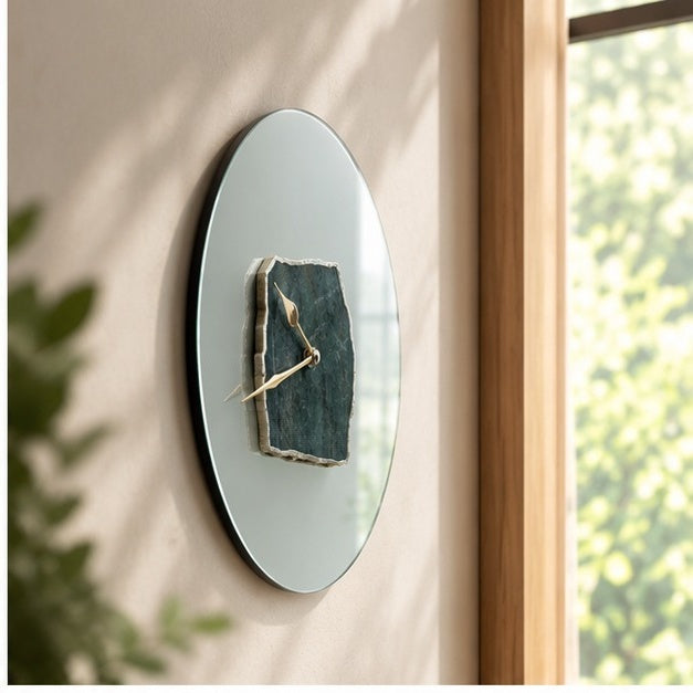 Frosted glass green aventurine wall clock seen at an angle against a window