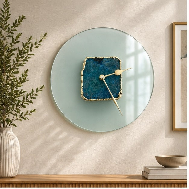 Glass agate wall clock, pale sea green disc with a teal agate slice at the centre, above a console