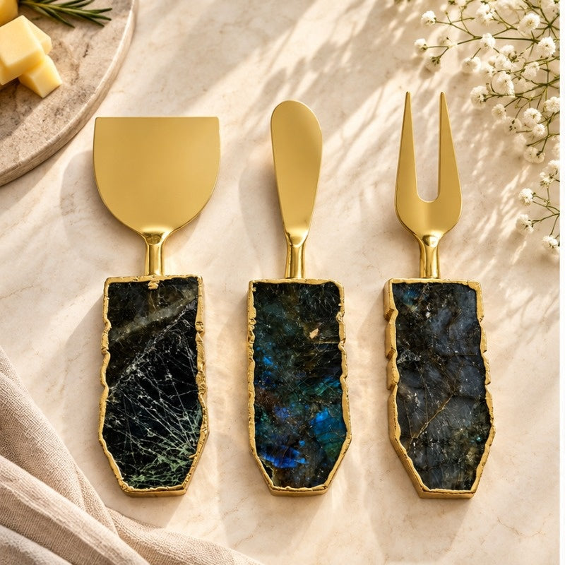 Labradorite cheese knives on a pale plate with cheese and white blossom