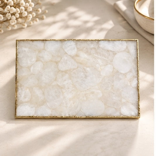 Large white crystal agate cheese platter with a gold frame and handles, on cream linen