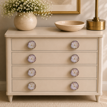 Eight pale pink quartz knobs across four drawers of a cream chest
