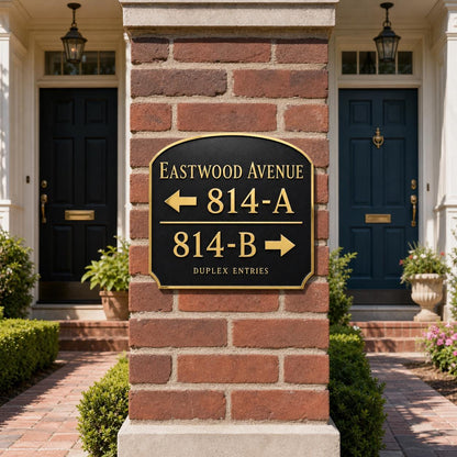 Duplex Entries plaque in antique brass, pictured on brickwork beside an entrance