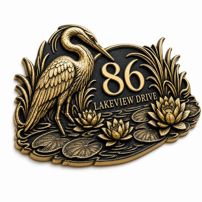 Heron and Waterlilies plaque in antique brass, angled view showing the relief, outline and lettering