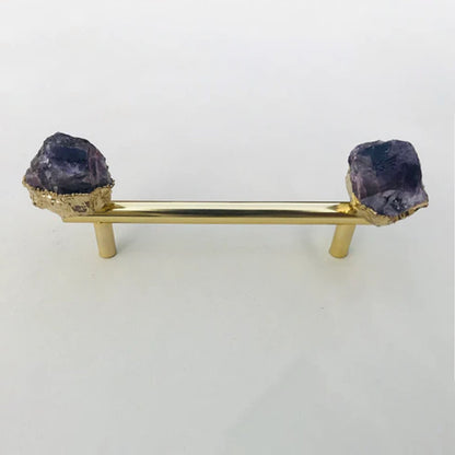 Gold bar pull with a raw amethyst crystal set in gold at each end