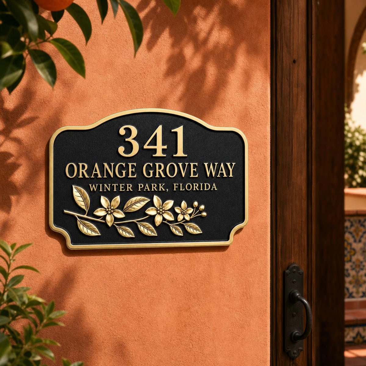 Orange Blossom name plate pictured beside a wooden doorway on a terracotta-coloured wall