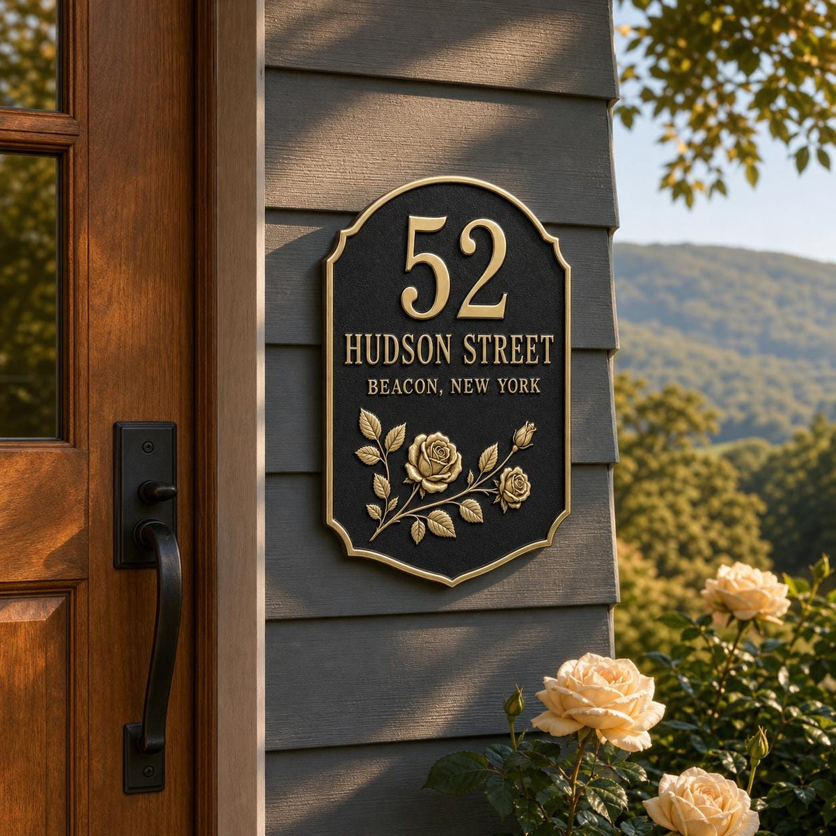 Rose plaque pictured on timber cladding beside an open wooden doorway