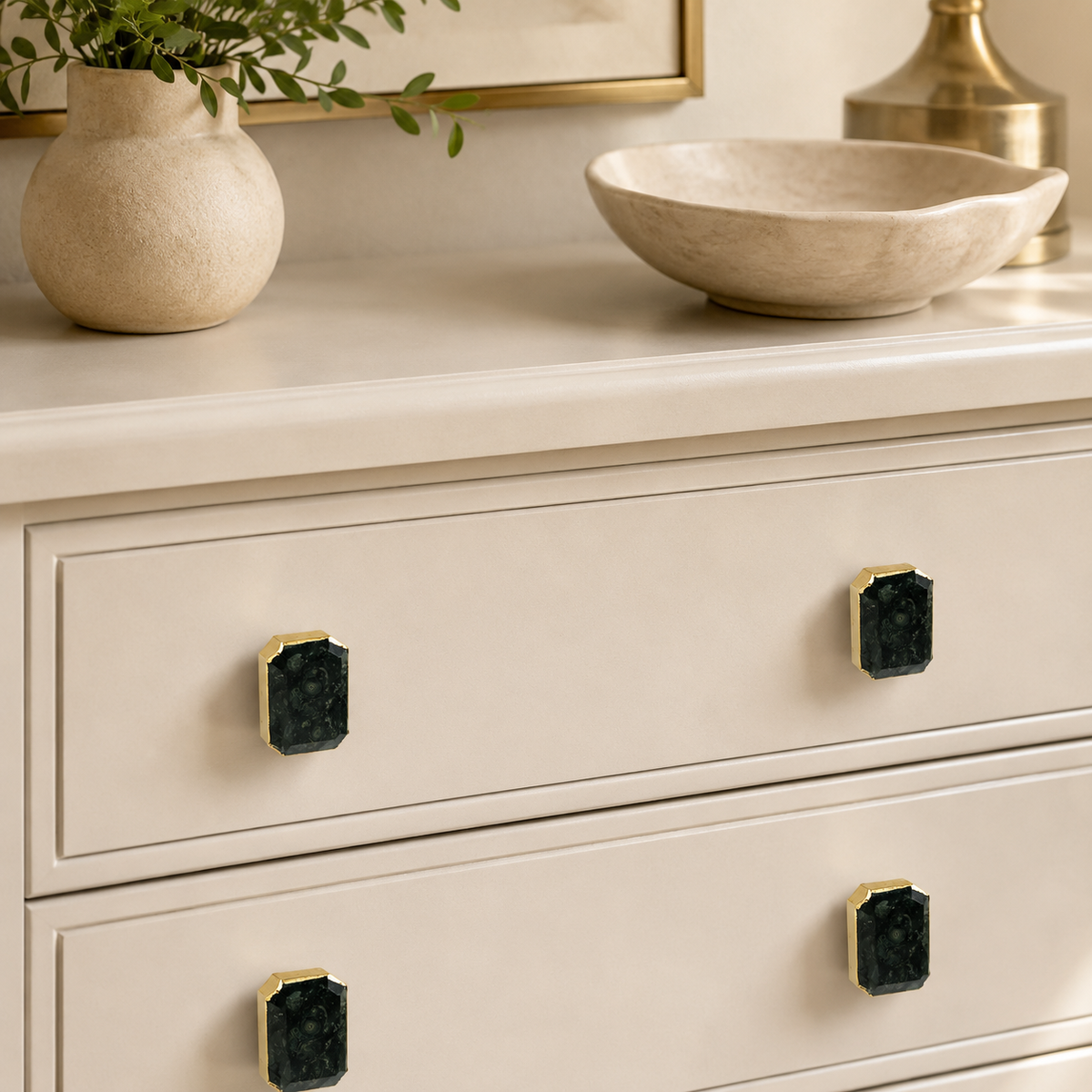 Closer view of the cream drawers, four emerald cut obsidian knobs