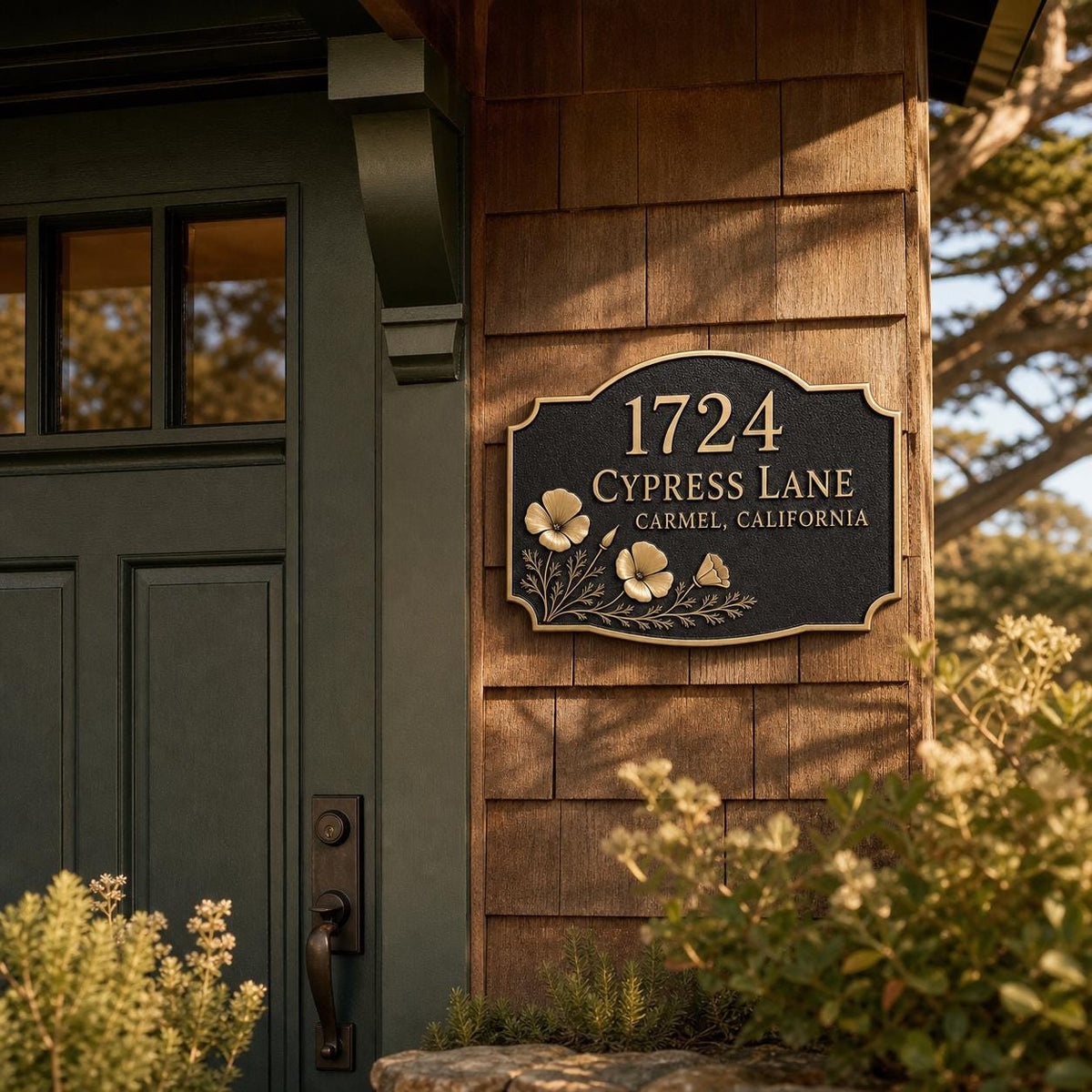 Poppy house name plate pictured beside a wooden entrance and a dark door