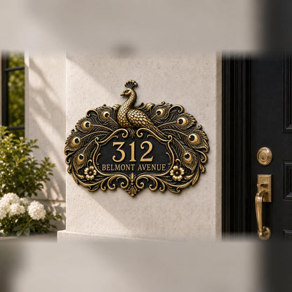 Peacock plaque in antique brass, pictured on a wall
