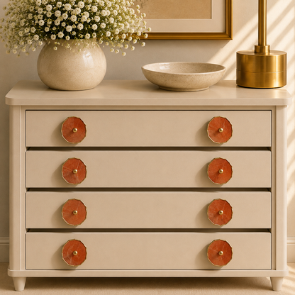 Eight terracotta stone knobs across four drawers of a cream chest