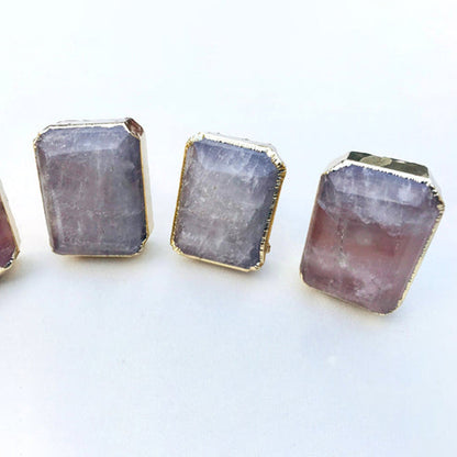 Three knobs close, pale translucent quartz inside slim gold bezels