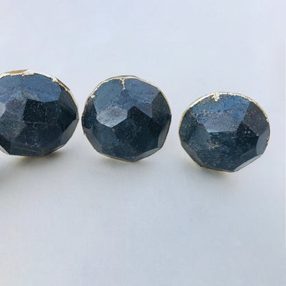 Three round knobs close, steel grey hematite with a metallic sheen