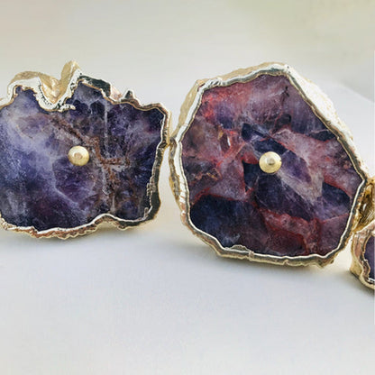 Two large slices close, deep purple and rust streaked with pale crystal