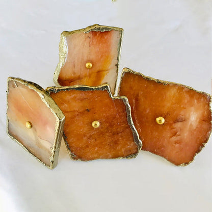 Four square slices on white, caramel and cream banded stone in gold
