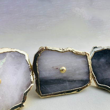 Three slices in a row, one milky white beside two of blue grey