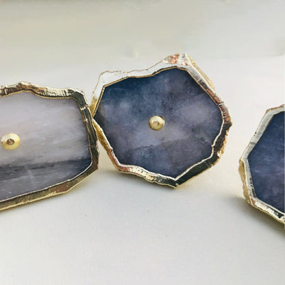 Three grey slices angled, pale translucent faces with gold edging