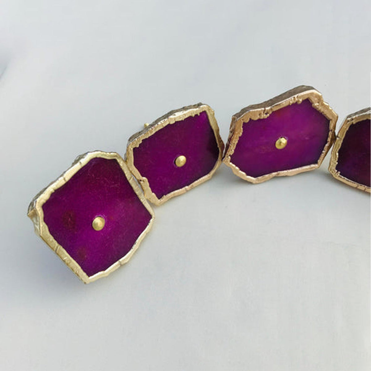 Four magenta slices close, vivid purple pink inside pale crusted edges