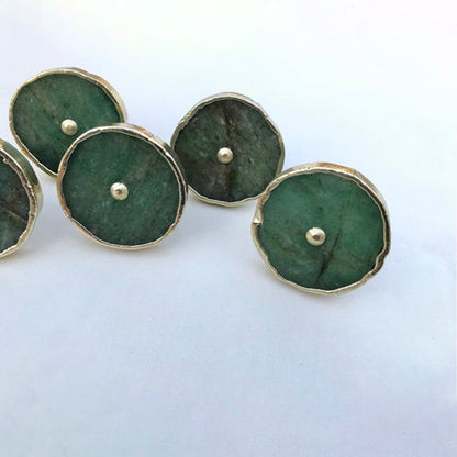 Four discs clustered, deep forest green stone under thin silver edging