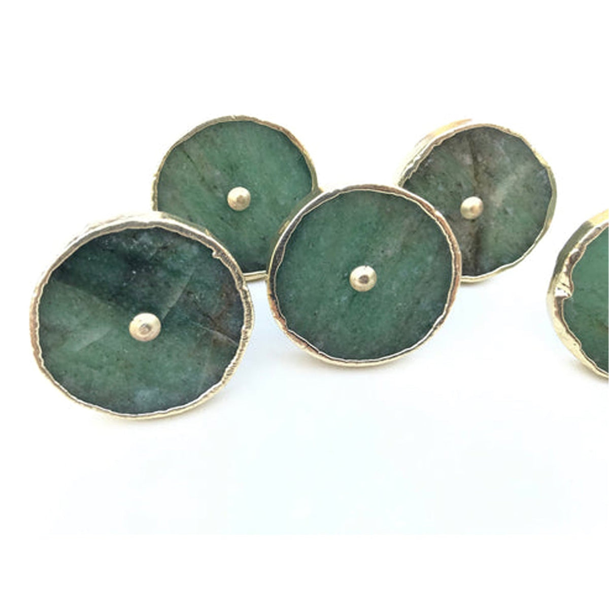 Four round knobs angled, mottled green faces with pale silver borders