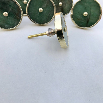 One disc tipped forward showing a brass back plate and long screw