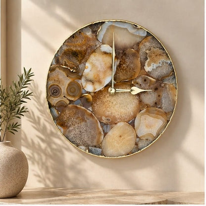 Large brown agate circular wall clock, brown and cream mosaic in a gold rim, above a console
