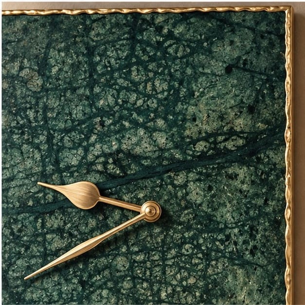 Close view of the deep green marble face and the gold hands