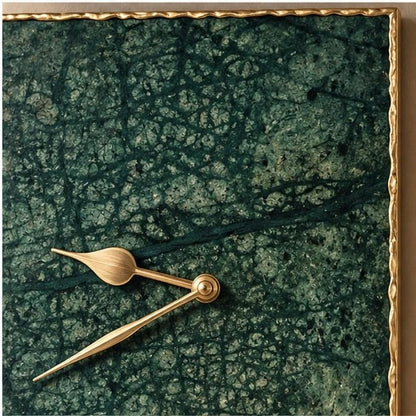 Close view of the deep green marble face and the gold hands