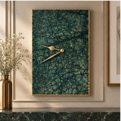 Large green marble rectangular wall clock in a gold frame, on a panelled wall above a mantel