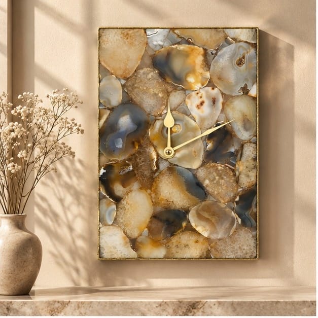 Large brown crystal agate rectangular wall clock in a gold frame, beside dried blossom