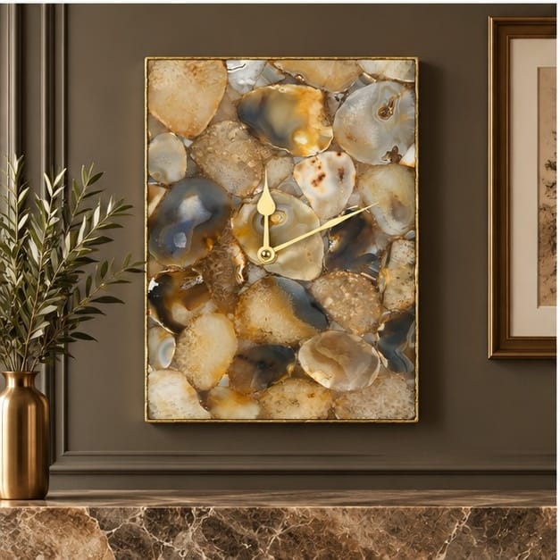 Brown crystal agate wall clock on a dark wall beside a framed picture