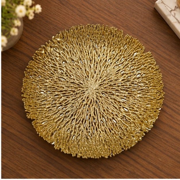 Coral metal tray in gold on a dark wood table