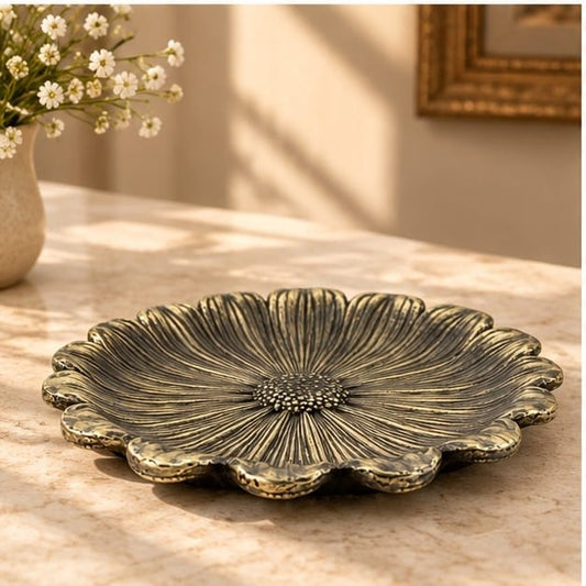 Sunflower metal tray, scalloped petals around a textured seed head centre, on a pale counter