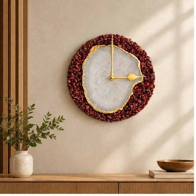 Burnt red crystal agate wall clock, deep red rim around a pale agate face, above a console