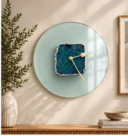 Glass agate wall clock in the gold finish, hung beside a framed print