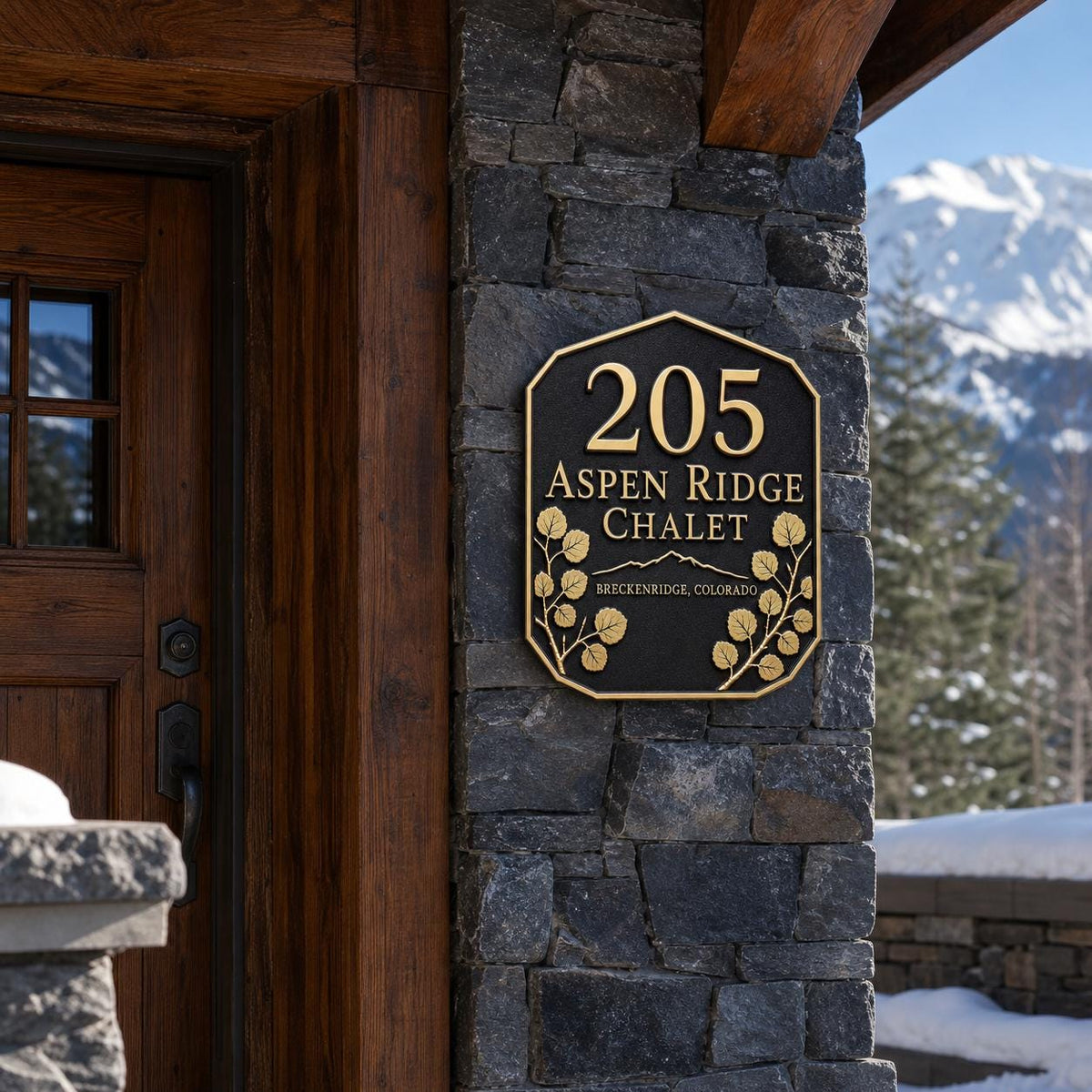 Aspen Leaf plaque pictured on a stone entrance wall