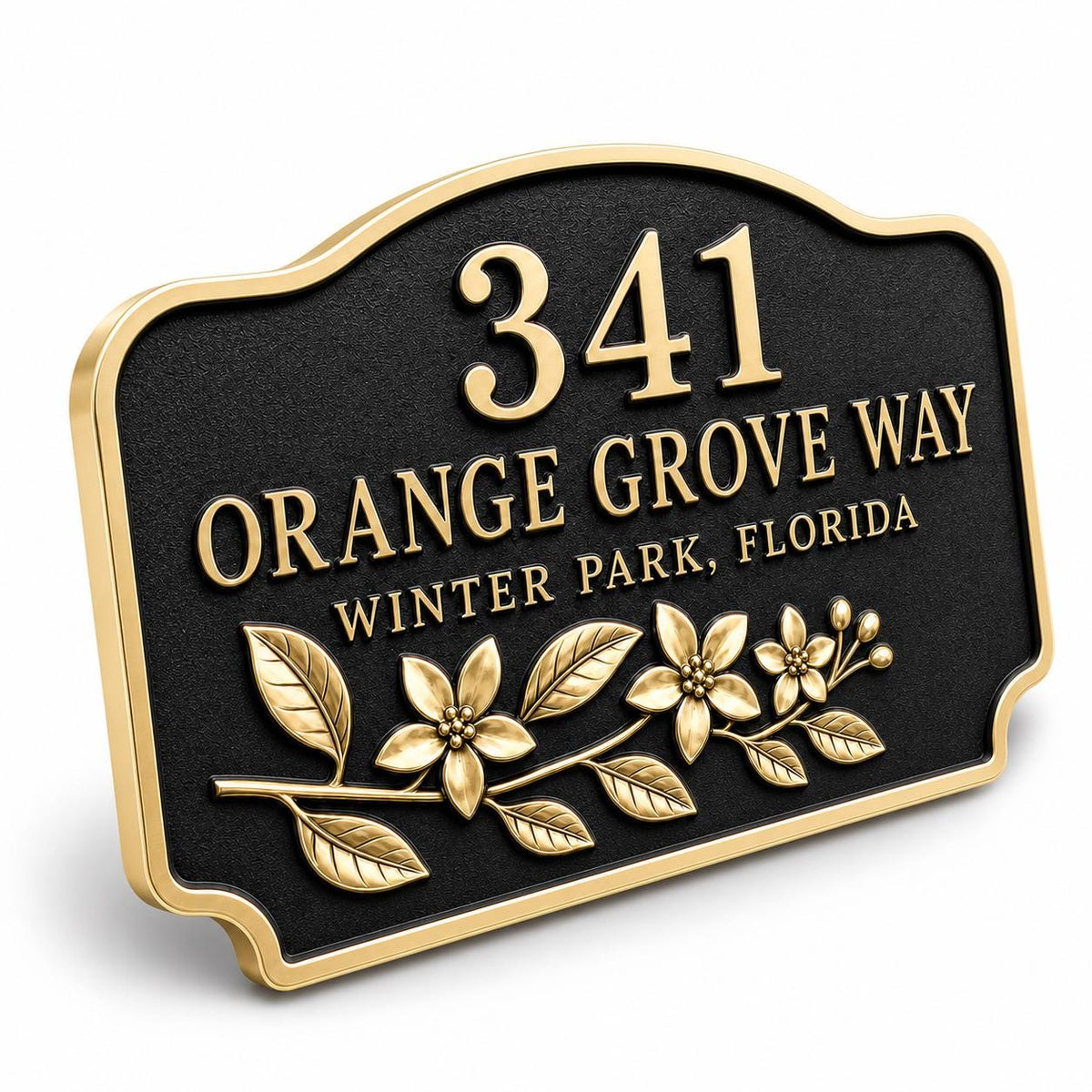 Angled Orange Blossom plaque showing raised antique-brass lettering against a dark ground