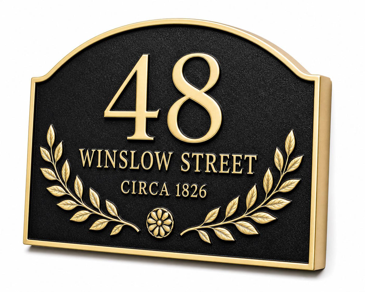 Angled Arched Laurel plaque showing raised lettering and an antique-brass border